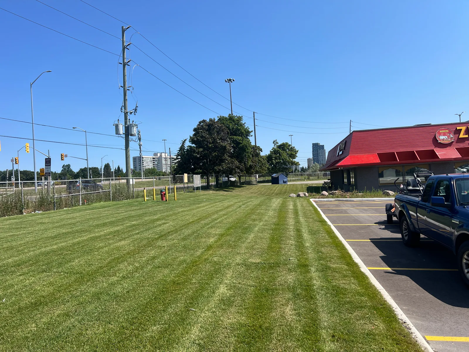 Striped commercial lawn maintained by PineWorks