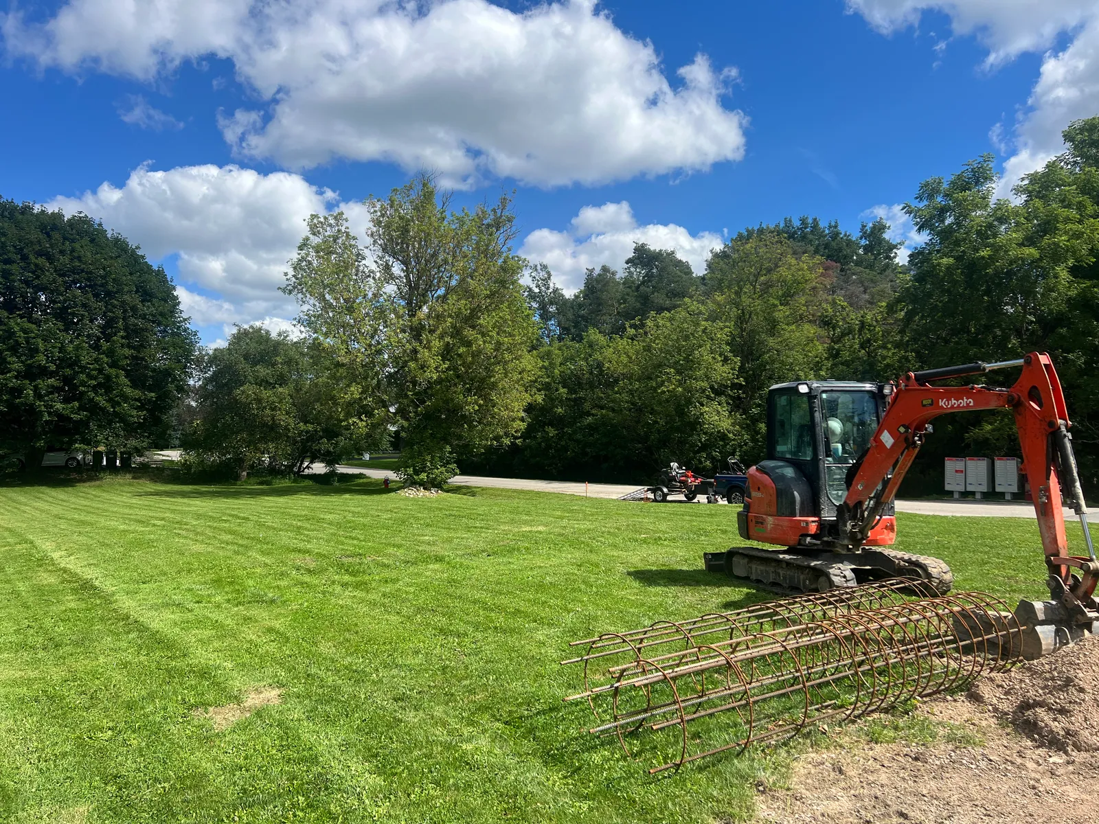Maintained open lawn with compact equipment at the edge of the property